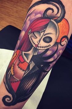 a person with a tattoo on their arm that has a skull and a woman's face