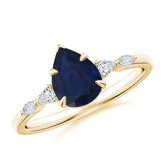 a yellow gold ring with an oval shaped blue sapphire and three white diamonds on the side