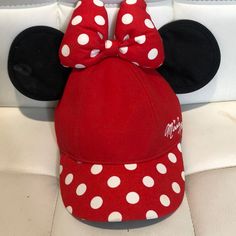 a red minnie mouse hat with white polka dots