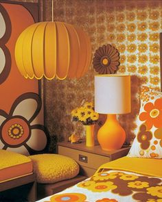 a bedroom with yellow and orange decor on the walls, bedding and nightstands