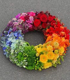 an arrangement of flowers arranged in the shape of a wreath