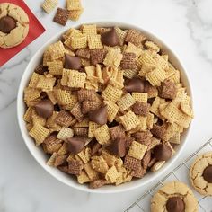 a white bowl filled with chex mix