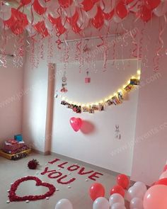 the room is decorated with balloons and streamers for valentine's day party decorations