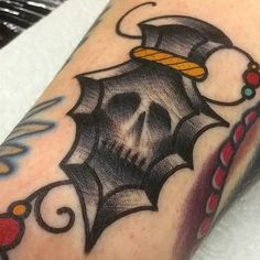 a skull with a hat on it's head is shown in this tattoo design