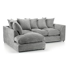 a gray sectional couch with pillows on the back and armrests, in front of a white background