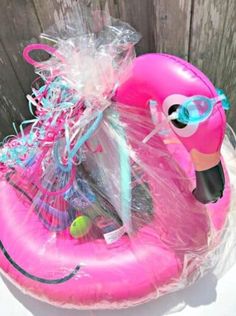 an inflatable pink flamingo with sunglasses on it's head and some other items