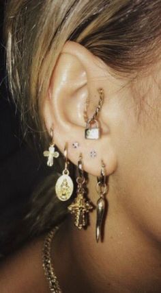 a close up of a person's ear with some earrings on top of it