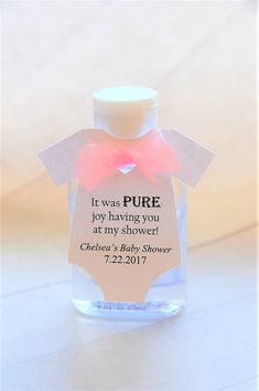 a baby shower bottle with a pink bow on it's label that says, it was pure joy having you at my shower