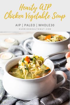 two white bowls filled with chicken vegetable soup on top of a blue and white towel