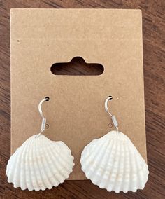 These handmade sea shell earring are perfect for beach lovers.  They are delicate dangle silver earrings. Great as a gift for loved ones. White Shell-shaped Ocean-inspired Jewelry, Ocean-inspired White Shell-shaped Jewelry, Silver Shell With Ocean-inspired Style For Vacation, Silver Ocean-inspired Shell For Vacation, White Shell-shaped Earrings For Vacation, Ocean-inspired Shell Earrings As Gift, Nickel-free Shell-shaped Earrings Gift, Sterling Silver Shell Earrings For Gift, Nickel Free White Shell Jewelry