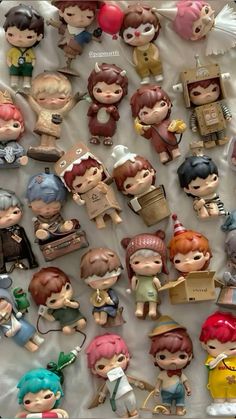 many little figurines are displayed in a box