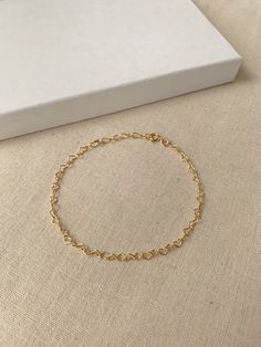 "Hearts are melting for this dainty yet durable mini heart chain bracelet! 💛 This unique chain is sensitive skin and water safe, and is made to live your life in! Wear this minimal piece to brunch, or on a date... this simple heart chain looks lovely anywhere you take it! Details: * 2.8x6mm 14K Gold Filled or 925 Sterling Silver chain * Dainty 14K Gold Filled or 925 Sterling Silver clasp * 14/20 gf stamp for authenticity * Choose your length (each bracelet comes with a .75\" extender chain for Minimalist Heart-shaped Bracelet With Delicate Chain, Dainty Heart Bracelets For Everyday, Minimalist Heart Bracelet With Delicate Chain For Everyday, Heart Chain Bracelet As Gift, Minimalist Heart Bracelet With Delicate Chain, Minimalist Everyday Heart Bracelet With Delicate Chain, Dainty Delicate Chain Bracelets For Valentine's Day, Adjustable Heart-shaped Delicate Chain Bracelet, Adjustable Delicate Heart Chain Bracelet