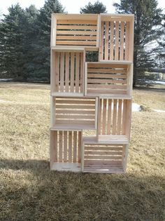 a tall wooden structure sitting in the middle of a field