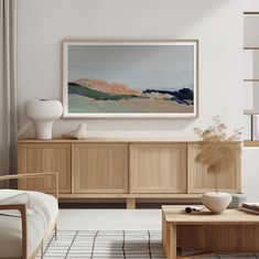 a living room scene with focus on the coffee table and art hanging over the entertainment center