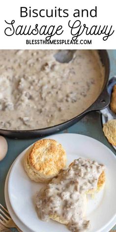 biscuits and sausage gravy on a white plate next to an iron skillet