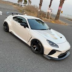 a white sports car parked on the street