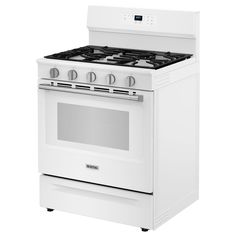 a white stove top oven sitting inside of a kitchen