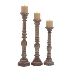 three wooden candlesticks sitting next to each other