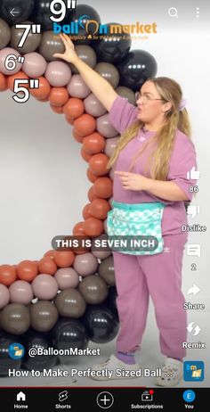 a woman is standing in front of a balloon arch with the number six on it