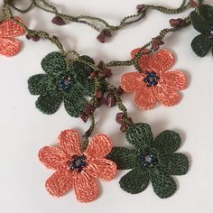 the necklace is decorated with flowers and beads