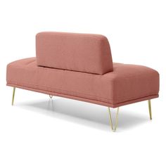 a pink couch sitting on top of a white floor