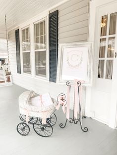 a baby's carriage sitting on the front porch