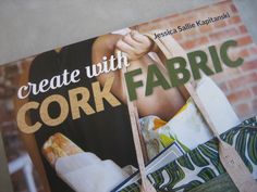 a magazine with an image of a woman holding bags and the title create with cork fabric