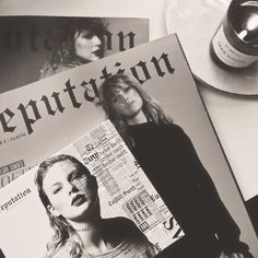 a black and white photo of two people on the cover of a magazine next to a bottle of wine