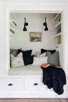 a room with white walls and shelves filled with pillows