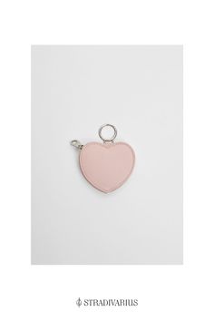 a pink heart shaped keychain on a white background with the words straddva