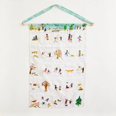 a white wall hanging with children's pictures on it