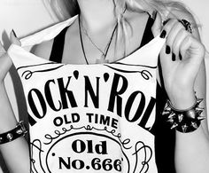 a woman holding up a sign that says rock'n'roll old time and no 666