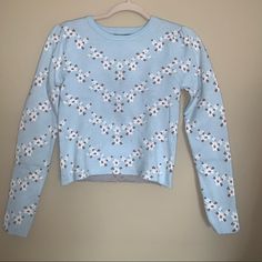 Light Blue Forever 21 Sweater With White Flowers & Small Brown Detailing , Shoulders Have A Little Puff Size Small New With Tags , Never Worn Winter Blue Floral Print Tops, Blue Floral Print Top For Winter, Blue Floral Print Tops For Winter, Reindeer Christmas Sweater, Purple Flame, Light Pink Sweaters, Cutout Sweater, Marled Sweater, White Knit Sweater