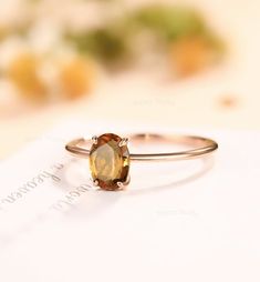 a close up of a ring with an orange stone