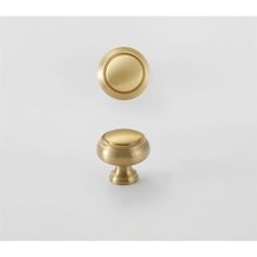 an image of a gold knob on a white background with the door handle in view