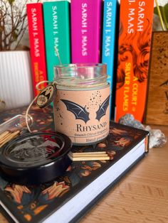 a candle sitting on top of a book next to some books