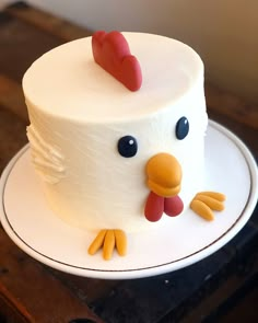 a white cake with a chicken on top