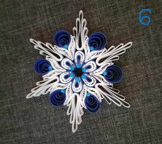 a paper snowflake with blue and white decorations