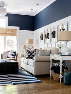 a living room with blue walls and white furniture