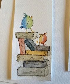 two cards with birds sitting on top of books and one bird is perched on the book