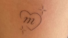 a woman's stomach with a heart and the letter m on her left side