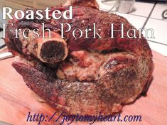 roasted fresh pork ham on a cutting board with the words roasted fresh pork ham