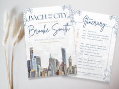 two wedding cards with the city skyline in blue and white, on top of each other