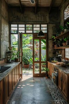 an open kitchen with wooden cabinets and plants on the counter tops, along with a tiled floor