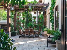 an outdoor dining area with potted plants and chairs