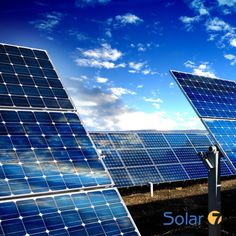 several solar panels with the word solar on them in front of blue sky and clouds