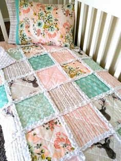 a baby crib with a quilt and pillow on it