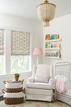 a baby's room with a rocking chair, crib and bookshelf