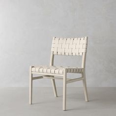 a white chair sitting on top of a gray floor