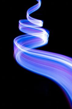 a long exposure photo of blue and purple lines